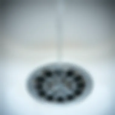 Close-up of a bathroom sink drain showing water accumulation