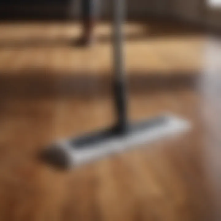 Close-up of a person using a microfiber mop on a wooden floor