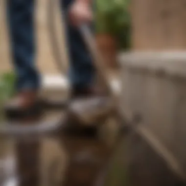 A homeowner using a drain snake to clear a clog