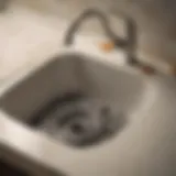 A detailed view of a clogged kitchen sink drain