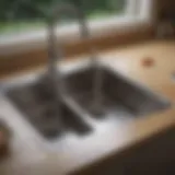 Close-up of a kitchen sink with plumbing under the counter.